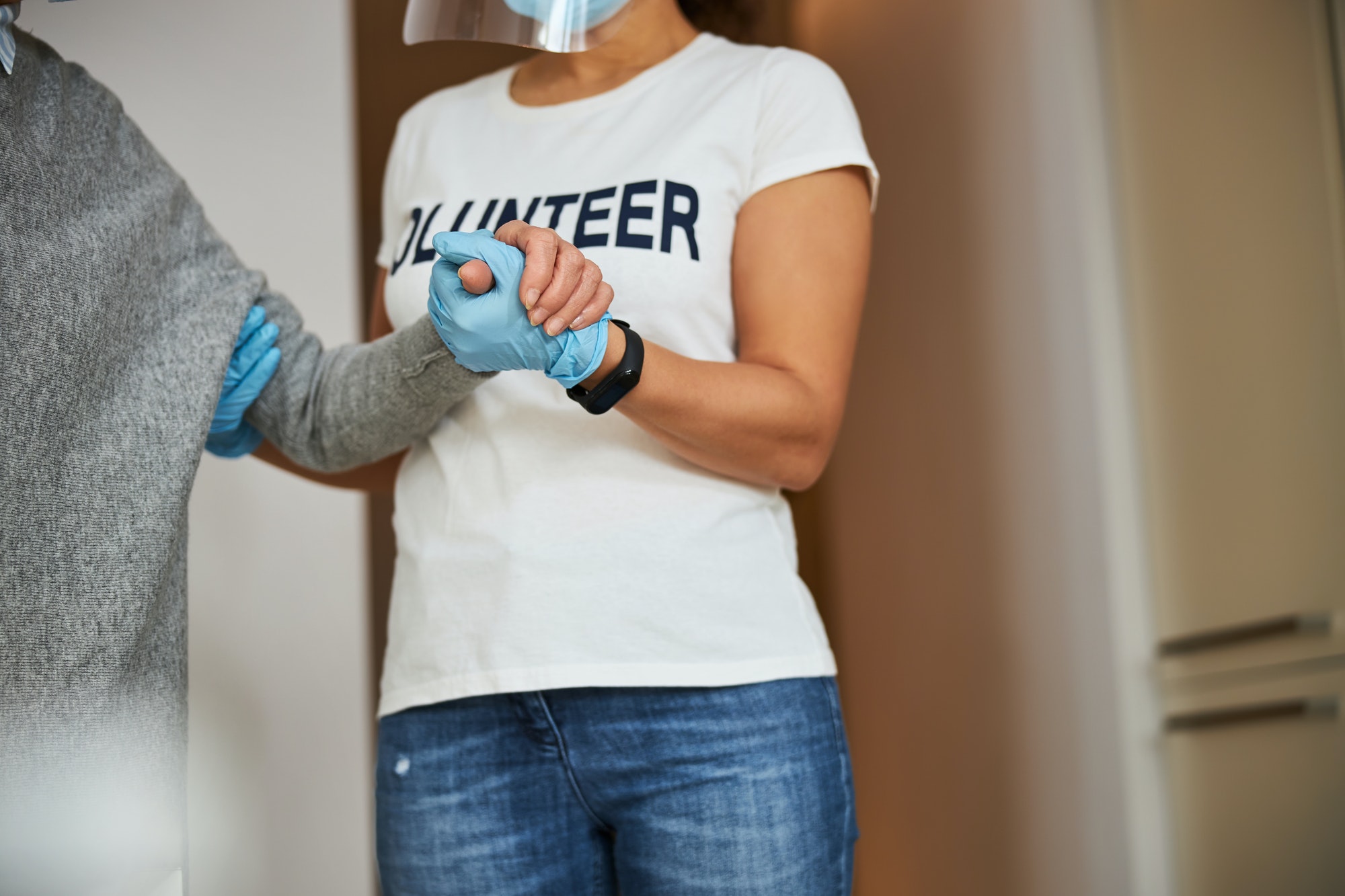 Caregiver lending a helping hand to a pensioner